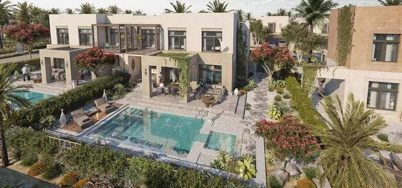 Shaden villas around a landscaped pool at Al Jurf Gardens