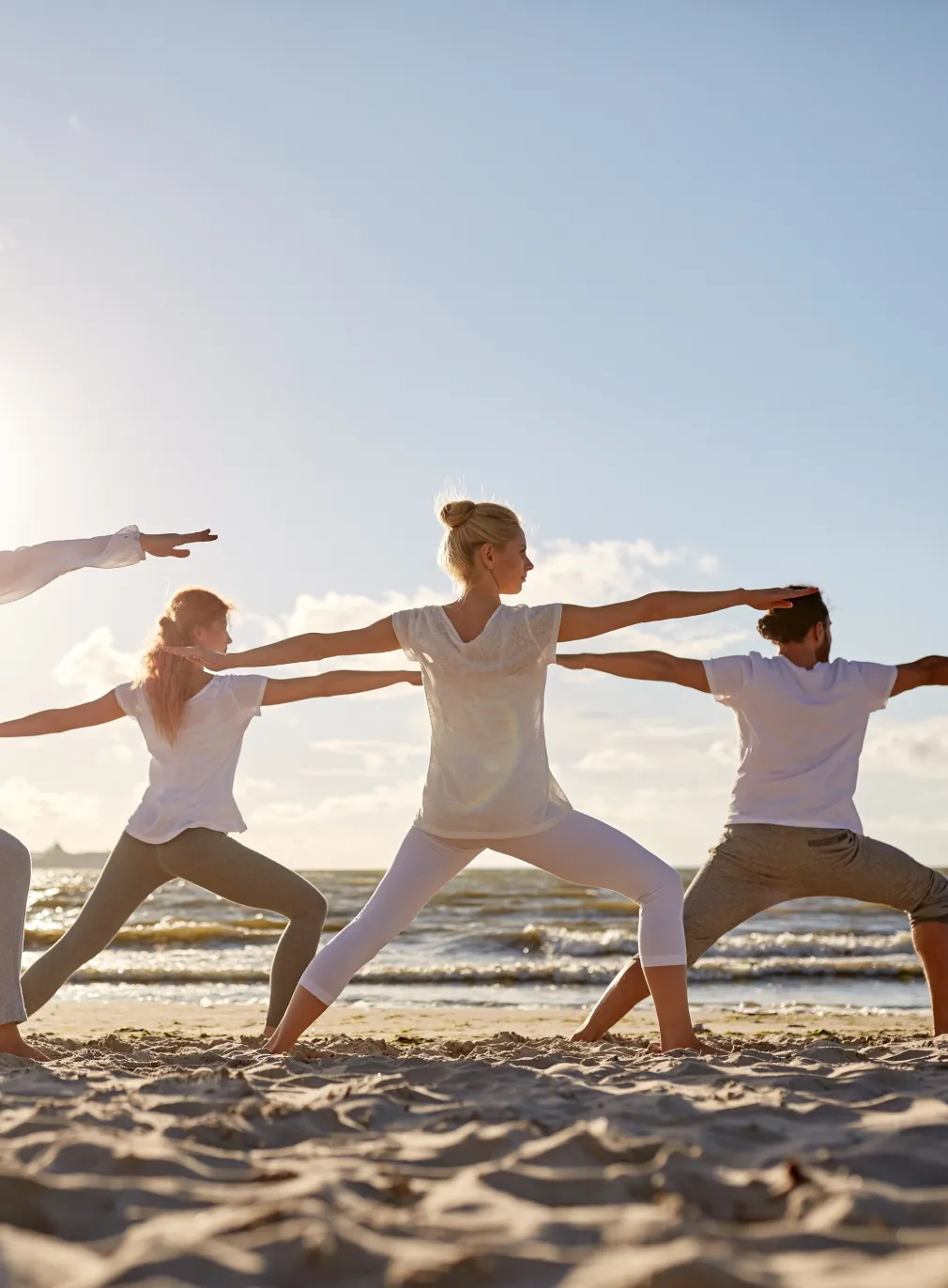 Residents practising yoga on the private beach